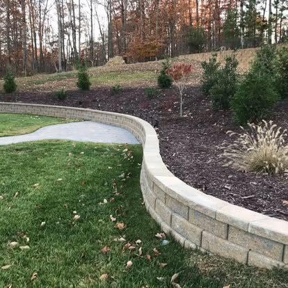 Curved retaining wall with fresh plantings